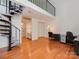 Office area featuring hardwood floors, a spiral staircase, and built-in storage at 4025 Woodfox Dr, Charlotte, NC 28277