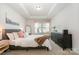 Bright bedroom with tray ceiling, plush carpet, neutral walls, and a large window that brings in natural light at 4117 Galloway Park Dr, Charlotte, NC 28262