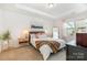 Well-lit main bedroom features a tray ceiling, neutral walls, plush carpet, and stylish decor with ample sunlight at 4117 Galloway Park Dr, Charlotte, NC 28262