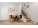 Cozy dining area with modern table set, decorative shelves, and staircase access to the upper level at 4117 Galloway Park Dr, Charlotte, NC 28262