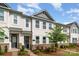 A well maintained townhome with stone accents, vinyl siding, manicured lawn and mature tree at 4117 Galloway Park Dr, Charlotte, NC 28262