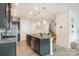 Stylish kitchen with granite counters, stainless appliances, island with bar seating, and modern pendant lighting at 4117 Galloway Park Dr, Charlotte, NC 28262