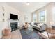 Cozy living room featuring a decorative fireplace, plush sofa, and lots of natural light at 4117 Galloway Park Dr, Charlotte, NC 28262