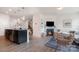 Open-concept layout combining living room with kitchen island, featuring fireplace and pendant lighting at 4117 Galloway Park Dr, Charlotte, NC 28262