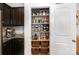 Organized walk-in pantry featuring custom shelving, storage containers, and woven baskets for optimal organization at 4117 Galloway Park Dr, Charlotte, NC 28262