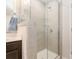 Modern shower with gray tile, glass door, and built-in glass shelving at 4117 Galloway Park Dr, Charlotte, NC 28262