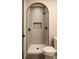 Bathroom featuring an arched walk-in shower with gray tiling, a built-in niche, and modern black fixtures and fixtures at 415 S Boyd St, Gastonia, NC 28052