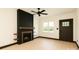 Bright living room featuring a modern fireplace with wood accents, a ceiling fan, and a window offering natural light at 415 S Boyd St, Gastonia, NC 28052