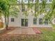 Back of house with vinyl siding, sliding glass doors leading to a patio, and lush trees overhead at 4208 Everest Dr, Gastonia, NC 28054