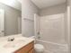 Neutral bathroom featuring a tub-shower combo, wood vanity, and a modern mirror at 4208 Everest Dr, Gastonia, NC 28054