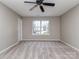 Large bedroom with carpet, a ceiling fan, a window for natural light, and a door to the hallway at 4208 Everest Dr, Gastonia, NC 28054