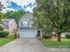 Charming two-story home with a green door, light siding, attached garage and an extended driveway at 4208 Everest Dr, Gastonia, NC 28054