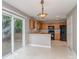 The eat-in kitchen boasts wood cabinets, black appliances, a breakfast bar, and sliding doors to the patio at 4208 Everest Dr, Gastonia, NC 28054