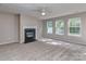 Living room with a fireplace, neutral carpet, and windows providing natural light, creating a welcoming space at 4208 Everest Dr, Gastonia, NC 28054