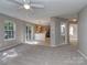 Open-concept living room with a ceiling fan and adjoining kitchen and powder room adding to the home's functionality at 4208 Everest Dr, Gastonia, NC 28054