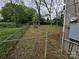 View of the backyard, including the fence, trees, and foliage at 435 W Sharpe St, Statesville, NC 28677