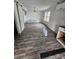 A bedroom with vinyl wood flooring, white walls, and is in need of repairs at 435 W Sharpe St, Statesville, NC 28677