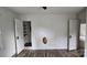 Bedroom with laminate flooring, an open closet, and multiple doorways allowing easy access to other rooms at 435 W Sharpe St, Statesville, NC 28677