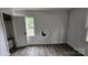 Bedroom with laminate flooring, a window for natural light, and an entrance to another room at 435 W Sharpe St, Statesville, NC 28677