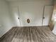 Bedroom featuring new flooring, white walls, and a pair of doors at 435 W Sharpe St, Statesville, NC 28677