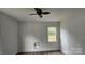 Modest bedroom featuring laminate flooring, natural light from a window, and a ceiling fan at 435 W Sharpe St, Statesville, NC 28677