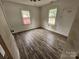 Bedroom showcasing hardwood floors and natural light from two windows at 435 W Sharpe St, Statesville, NC 28677