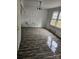 A bedroom has vinyl wood flooring and is in need of repairs at 435 W Sharpe St, Statesville, NC 28677
