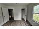 Bedroom with laminate flooring, a window for natural light, and doorways leading to additional spaces at 435 W Sharpe St, Statesville, NC 28677