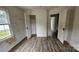 A bedroom has vinyl wood flooring, an open closet, and is in need of repairs at 435 W Sharpe St, Statesville, NC 28677