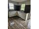 The bright kitchen offers white cabinetry, modern flooring, and black accents at 435 W Sharpe St, Statesville, NC 28677