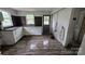 Kitchen with white cabinets, modern flooring, and black and white tile backsplash at 435 W Sharpe St, Statesville, NC 28677