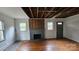 Living room with exposed ceiling, brick fireplace, and multiple windows at 435 W Sharpe St, Statesville, NC 28677