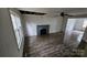 Bright living room featuring vinyl floors, a brick fireplace, and a view into another room at 435 W Sharpe St, Statesville, NC 28677
