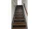 Close-up of a staircase featuring decorative black textured risers and a wooden handrail at 435 W Sharpe St, Statesville, NC 28677