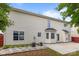 Back exterior view with a concrete patio and AC units, with stone landscaping at 4658 Cedar Rock Dr, Charlotte, NC 28273