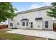 Back exterior of the home with a concrete patio and bay windows at 4658 Cedar Rock Dr, Charlotte, NC 28273
