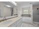 Bright bathroom featuring double sinks, a soaking tub, and a separate glass-enclosed shower at 4658 Cedar Rock Dr, Charlotte, NC 28273
