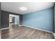 Bright, empty bedroom featuring dual paint colors, hardwood floors, and open layout at 4658 Cedar Rock Dr, Charlotte, NC 28273