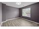 Well-lit bedroom with wood-look flooring and a large window at 4658 Cedar Rock Dr, Charlotte, NC 28273