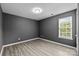 Bright bedroom featuring a large window providing natural light and modern gray walls at 4658 Cedar Rock Dr, Charlotte, NC 28273