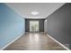 Empty bedroom featuring dual paint colors, hardwood floors, and large window at 4658 Cedar Rock Dr, Charlotte, NC 28273