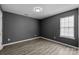 Clean bedroom with a large window offering natural light, finished with sleek wood flooring at 4658 Cedar Rock Dr, Charlotte, NC 28273