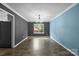 The dining room features a modern chandelier, large window, and gray and blue accent walls at 4658 Cedar Rock Dr, Charlotte, NC 28273