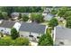 Aerial view of the back of a two story home with white siding, green lawn, and mature trees at 4658 Cedar Rock Dr, Charlotte, NC 28273