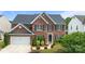 Charming two-story brick home with black shutters, landscaped yard, and an attached two-car garage at 4658 Cedar Rock Dr, Charlotte, NC 28273