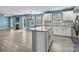 A open kitchen with marble countertops, white cabinets, and stainless steel appliances at 4658 Cedar Rock Dr, Charlotte, NC 28273