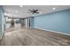 Spacious living room with hardwood floors, ceiling fan, and easy access to an eat-in kitchen at 4658 Cedar Rock Dr, Charlotte, NC 28273