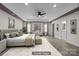 Spacious main bedroom with a tray ceiling, ceiling fan, and a serene, minimalist design at 4658 Cedar Rock Dr, Charlotte, NC 28273