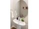 Elegant powder room featuring a pedestal sink, decorative mirror, and modern fixtures at 5058 Beargrass Dr, Dallas, NC 28034