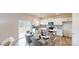 Bright and modern kitchen with an island, stainless steel appliances, and a connected dining area at 5058 Beargrass Dr, Dallas, NC 28034